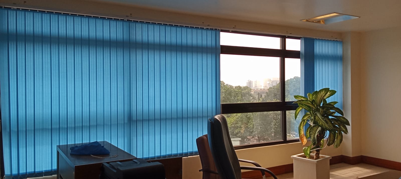 Vertical blinds fitted in an office overlooking the city