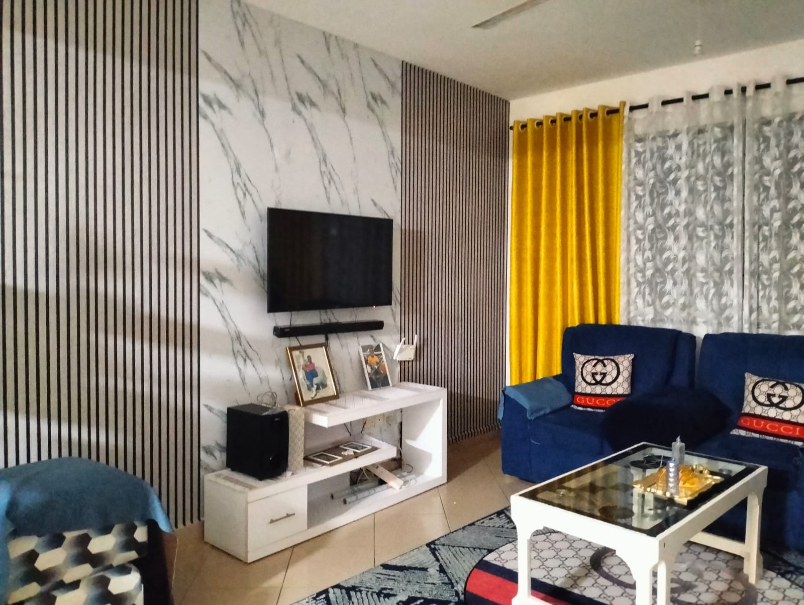 Residential living room with feature wallpaper and fitted curtains
